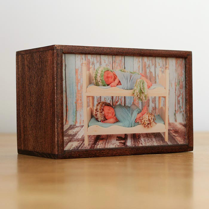 Image of a custom light box of two babies in a tiny bunk bed